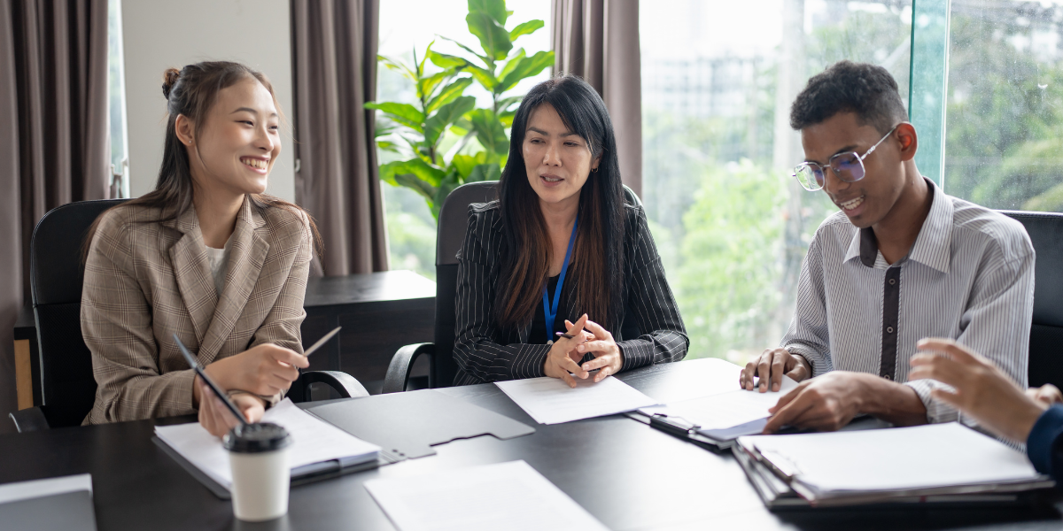 Insurance broker helping clients compare coverage options at a meeting
